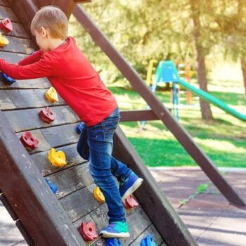 Cute Little Boy Playing On The Playground. Happy And Healthy Childhood. Kids Outdoors Playground.